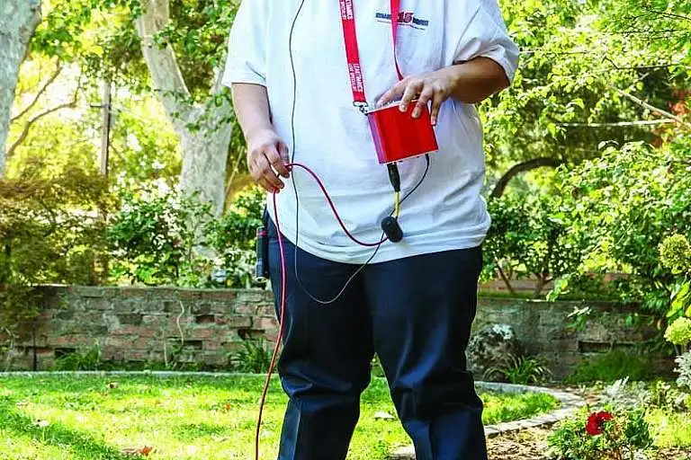 Savannah McGinnis uses a LeakTronics leak detector on a job.