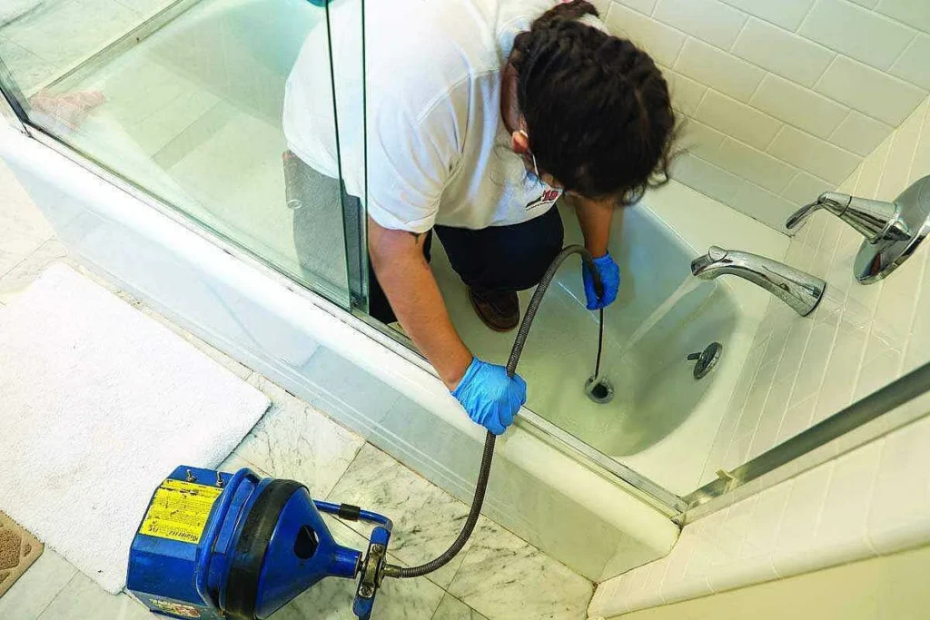 Savannah McGinnis snakes a drain using a cable machine from Gorlitz Sewer & Drain.